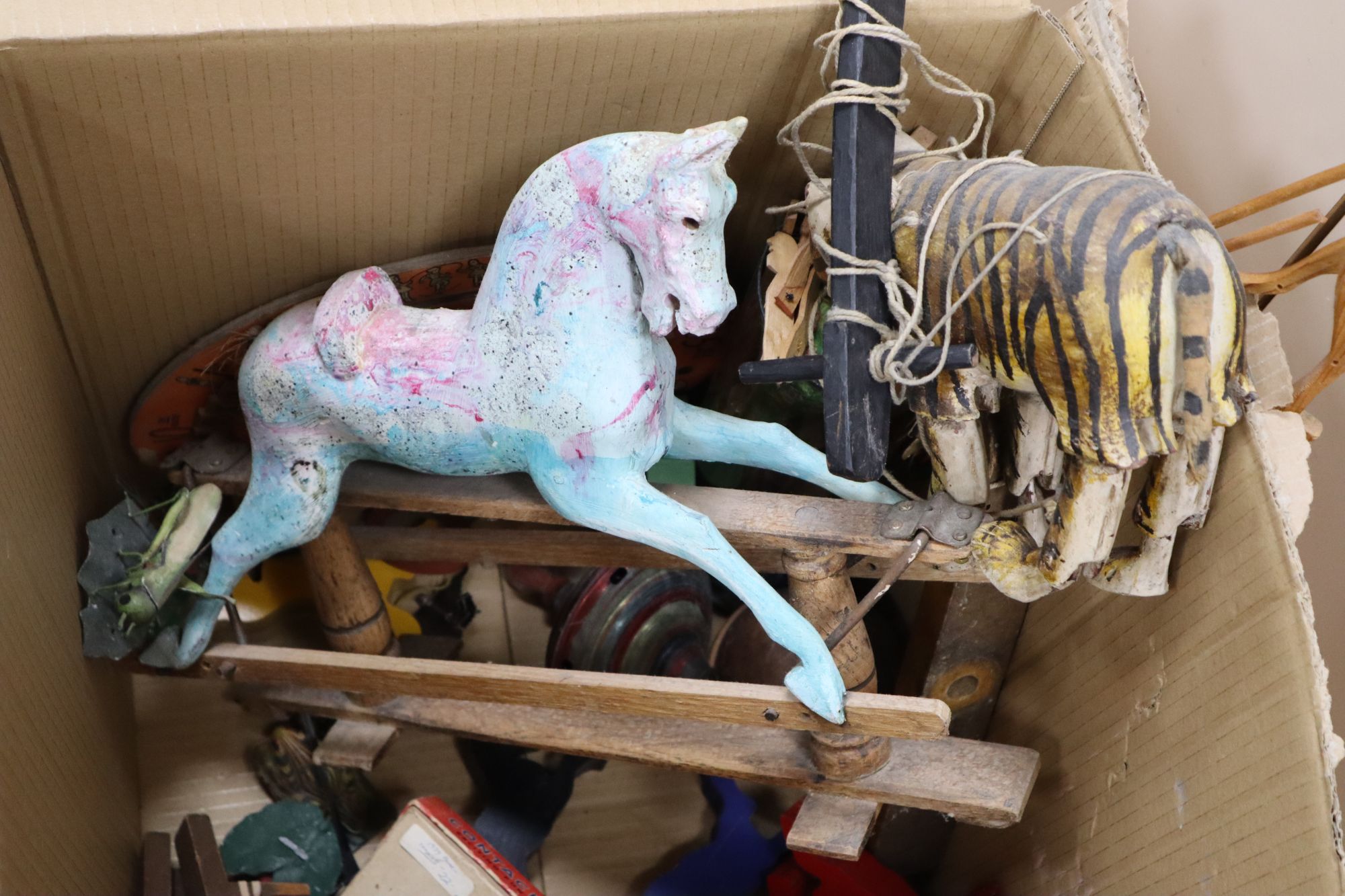 A Javanese tiger puppet, model wood rocking horse, a bowling game and quantity of mixed childrens toys games, late 19th/early 20th c